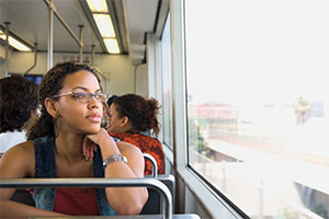 A female domestic violence victim is on the bus staring blankly into the distance.